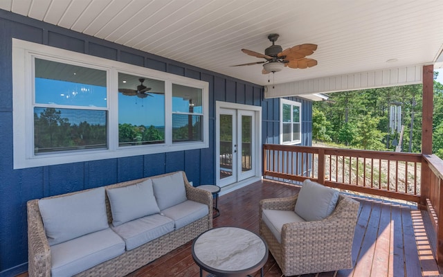 wooden deck featuring an outdoor living space, french doors, and ceiling fan