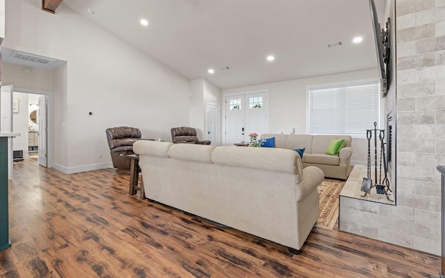 living room featuring recessed lighting, visible vents, dark wood finished floors, and a fireplace