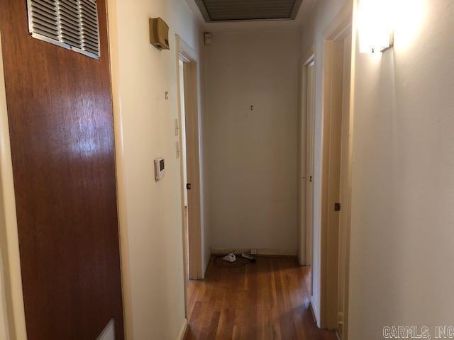 hallway featuring visible vents and wood finished floors