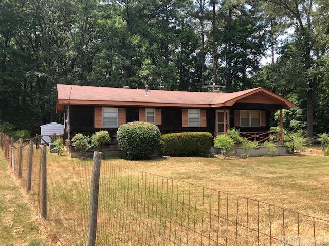 ranch-style house with a front lawn and fence