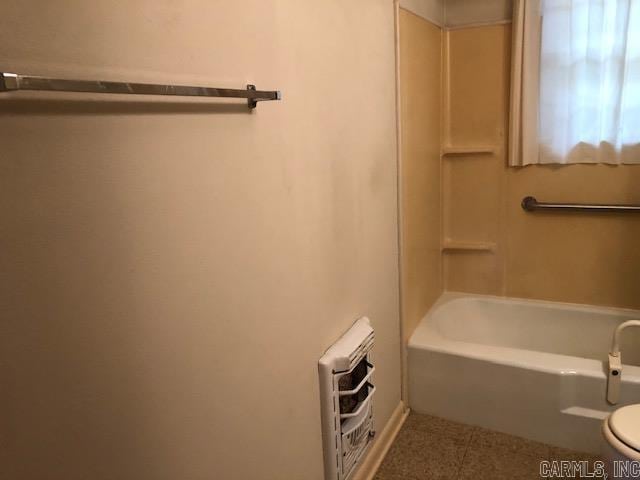 full bathroom featuring heating unit and toilet