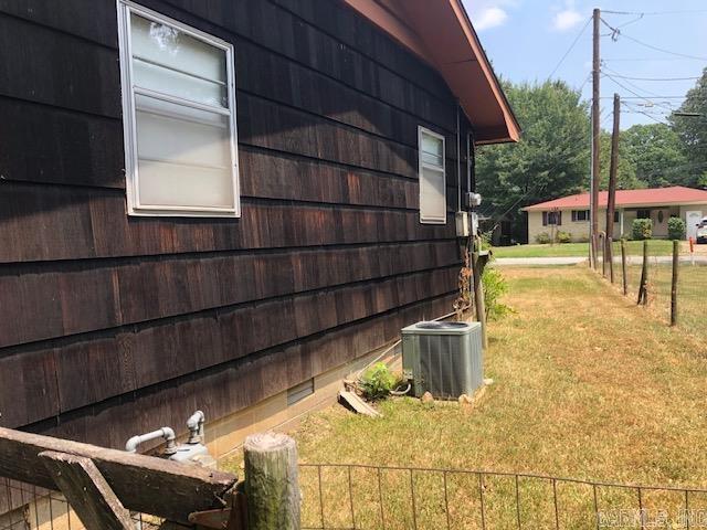 view of home's exterior featuring a yard and central AC