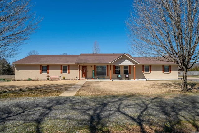 ranch-style home with brick siding and covered porch