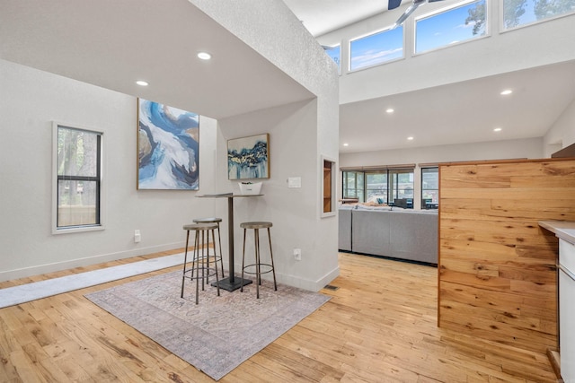 interior space featuring recessed lighting, baseboards, and light wood finished floors