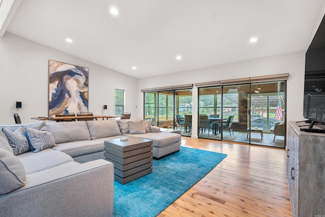 living room featuring recessed lighting, lofted ceiling, and wood finished floors