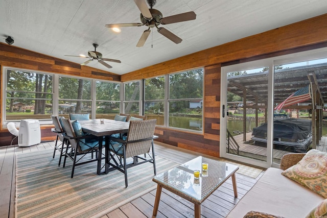 sunroom featuring lofted ceiling and ceiling fan