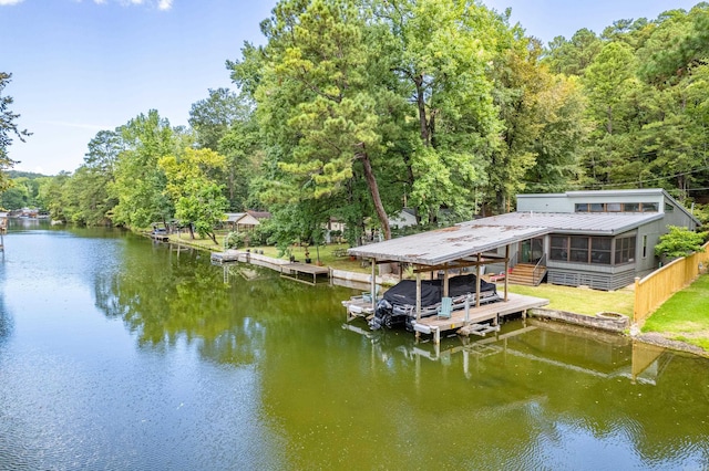 dock area with a water view and boat lift