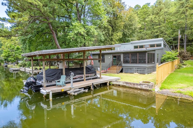 view of dock featuring a yard and a water view