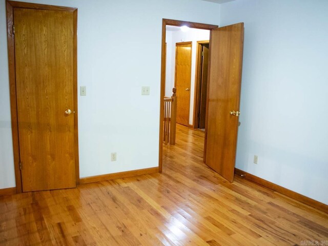 unfurnished bedroom with baseboards and light wood-style floors