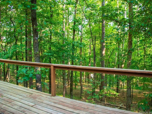 wooden terrace with a wooded view