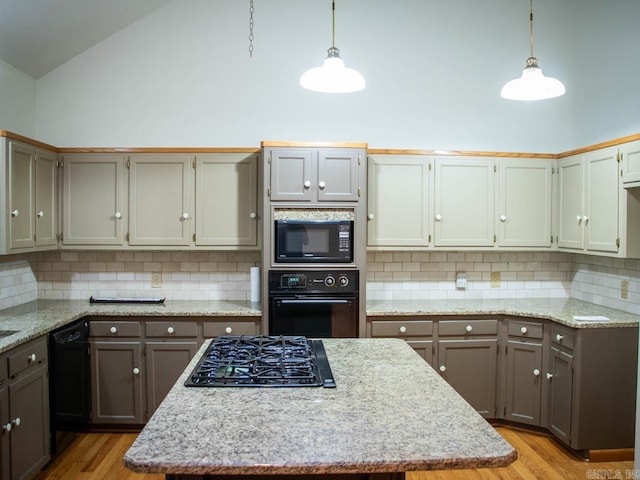 kitchen with light stone countertops, high vaulted ceiling, black appliances, and light wood-style flooring