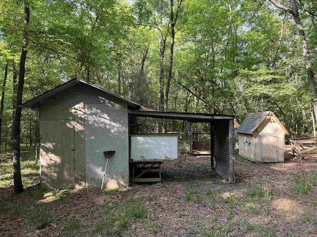view of shed featuring a view of trees