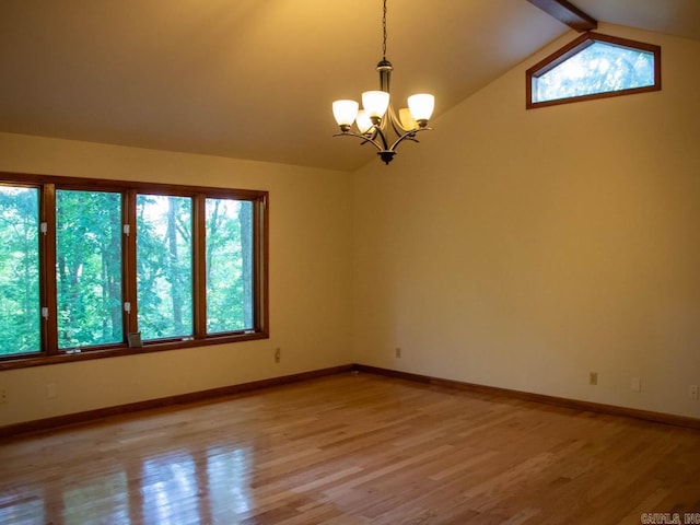 unfurnished room featuring light wood-style floors, baseboards, lofted ceiling with beams, and an inviting chandelier