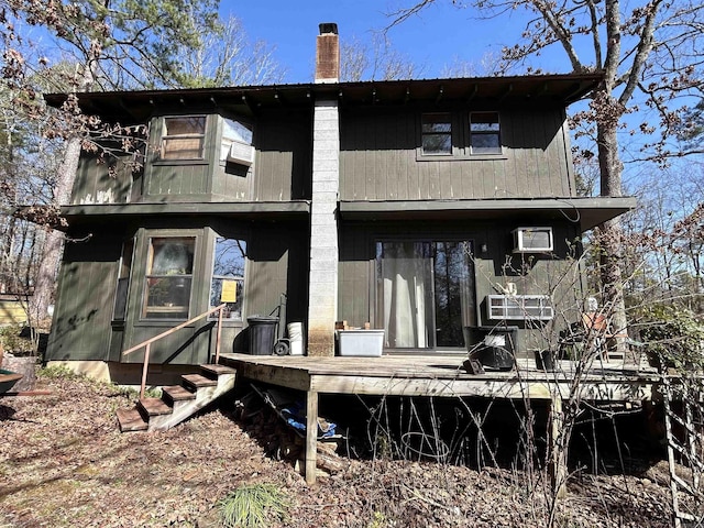 rear view of house featuring a deck and a chimney