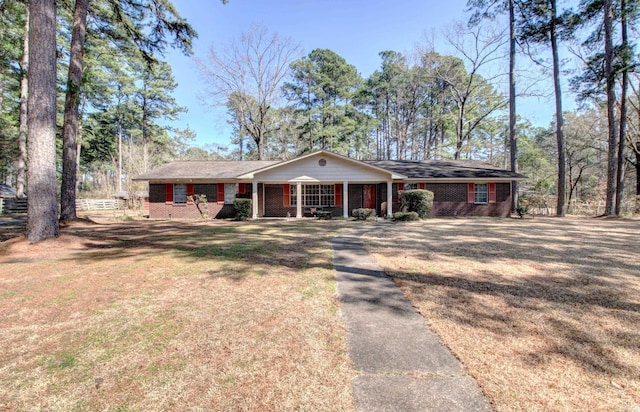 106 Pine Forest Ln, Fordyce, AR 71742 - ranch-style house featuring a front yard, brick siding, and covered porch
