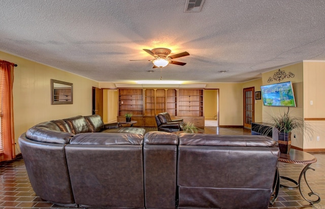 106 Pine Forest Ln, Fordyce, AR 71742 - living area with a textured ceiling, baseboards, visible vents, and ceiling fan
