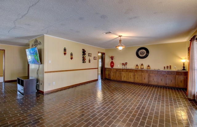 106 Pine Forest Ln, Fordyce, AR 71742 - misc room featuring visible vents, baseboards, crown molding, and brick floor