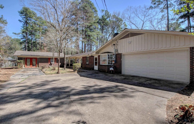 106 Pine Forest Ln, Fordyce, AR 71742 - view of front of property featuring french doors, brick siding, and driveway