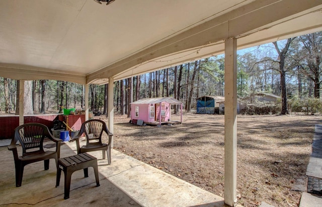 106 Pine Forest Ln, Fordyce, AR 71742 - view of patio / terrace with a storage unit and an outdoor structure