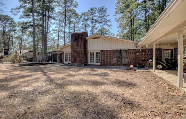 106 Pine Forest Ln, Fordyce, AR 71742 - view of side of property featuring brick siding, french doors, and a chimney