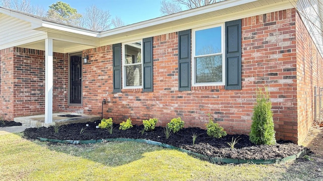 view of side of home with brick siding