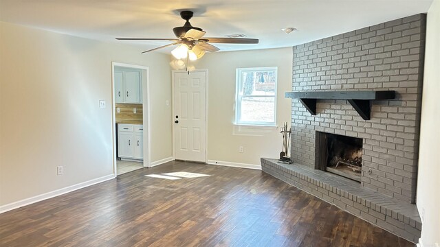 unfurnished living room with a ceiling fan, visible vents, dark wood-style floors, baseboards, and a fireplace