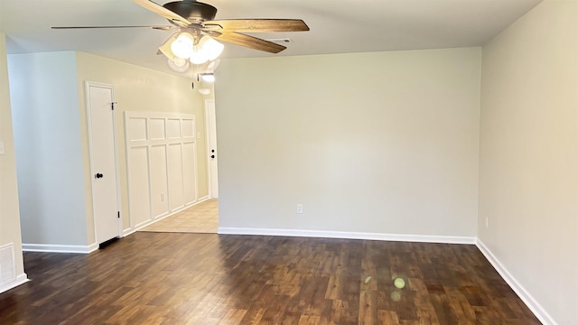 unfurnished room with visible vents, baseboards, ceiling fan, and wood finished floors