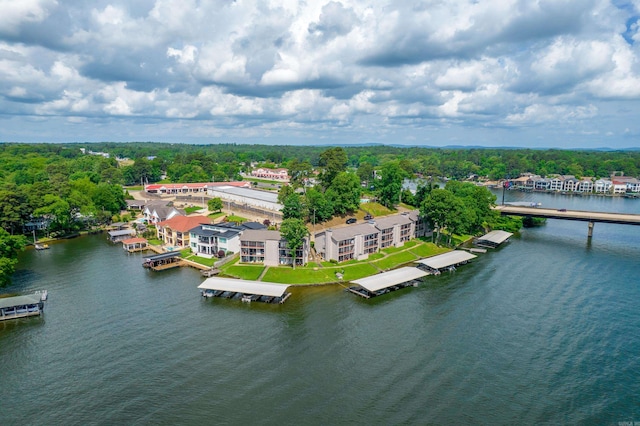 drone / aerial view with a forest view and a water view