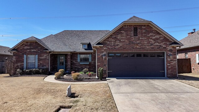 245 Fourwinds Dr, Conway, AR 72034 - ranch-style home featuring fence, roof with shingles, concrete driveway, an attached garage, and brick siding