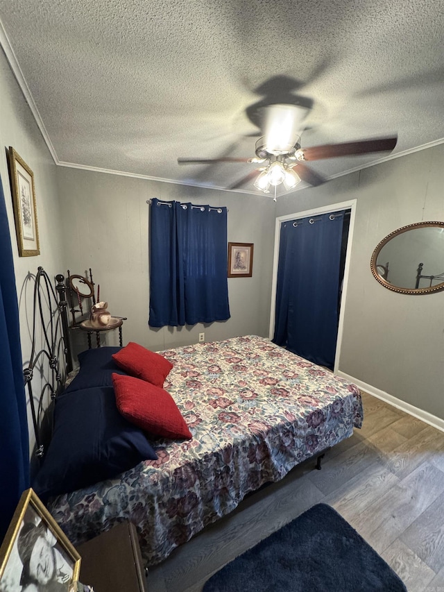 700 Thompson St, Mcgehee, AR 71654 - bedroom featuring a textured ceiling, wood finished floors, and ornamental molding