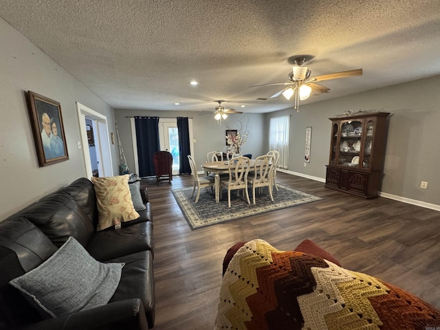 700 Thompson St, Mcgehee, AR 71654 - living room featuring a textured ceiling, baseboards, dark wood-type flooring, and ceiling fan