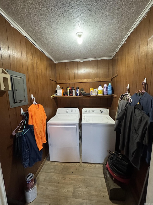700 Thompson St, Mcgehee, AR 71654 - laundry room featuring wood finished floors, washing machine and dryer, laundry area, and crown molding