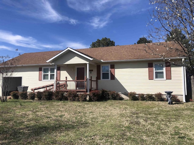 ranch-style home with a front lawn, a porch, and a shingled roof