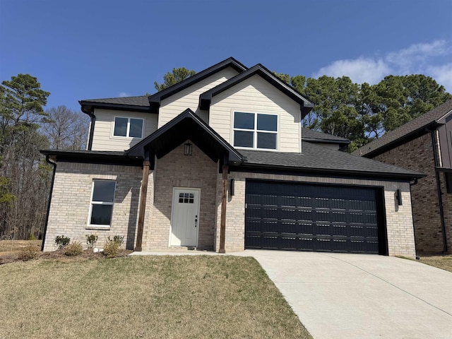 view of front of property with a front lawn, brick siding, a garage, and driveway