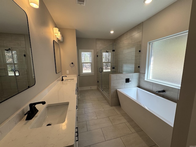 bathroom featuring visible vents, a sink, a shower stall, tile patterned floors, and a bath