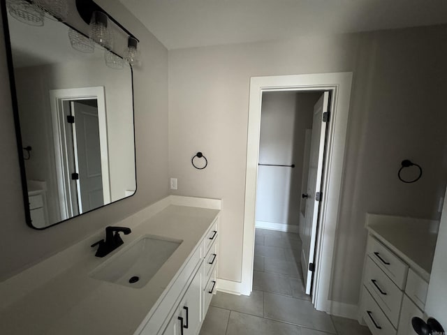 bathroom featuring tile patterned floors, baseboards, and vanity