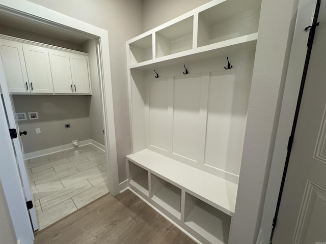 mudroom featuring baseboards and wood finish floors