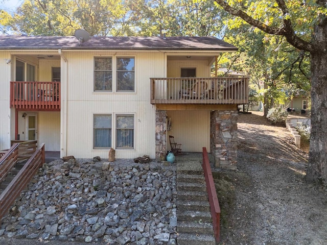 back of property featuring a balcony