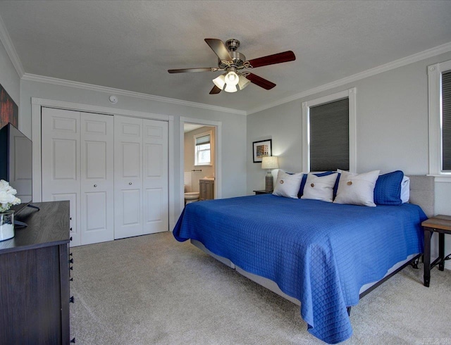 bedroom featuring ornamental molding, a ceiling fan, a textured ceiling, a closet, and carpet floors