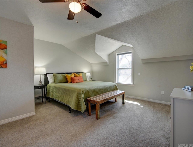 bedroom featuring vaulted ceiling, light colored carpet, baseboards, and a textured ceiling