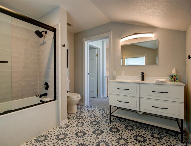 full bathroom featuring vanity, lofted ceiling, shower / bath combination, tile patterned floors, and toilet