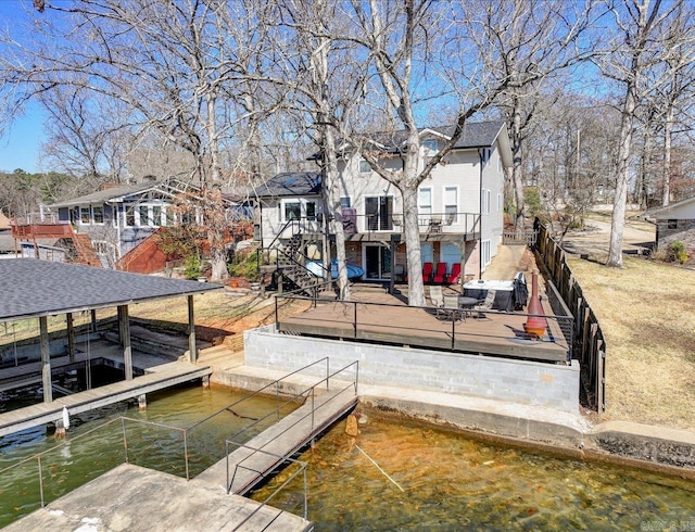 view of dock featuring a residential view, boat lift, and stairs
