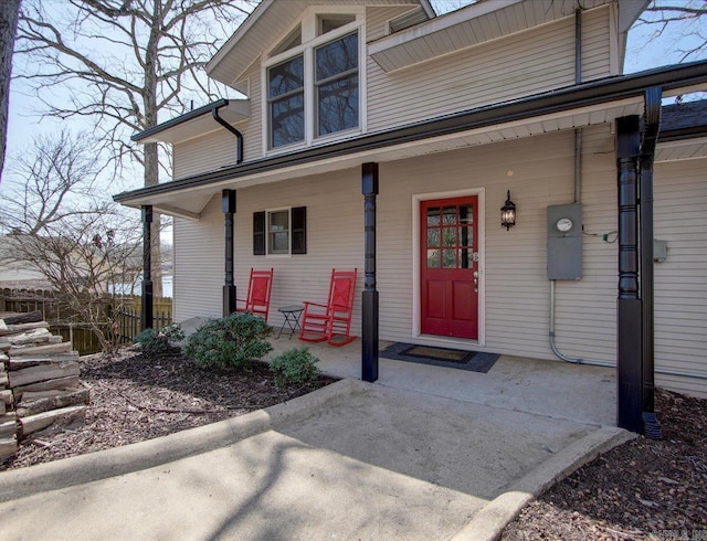 view of exterior entry featuring covered porch