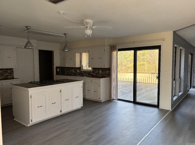 240 Timberlane Dr, Magnolia, AR 71753 - kitchen with a ceiling fan, dark wood finished floors, stovetop, white cabinets, and dark countertops