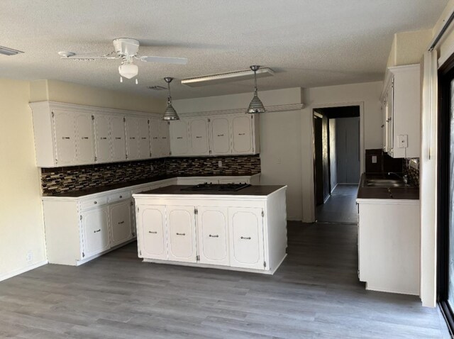 240 Timberlane Dr, Magnolia, AR 71753 - kitchen featuring visible vents, dark countertops, a ceiling fan, and white cabinetry