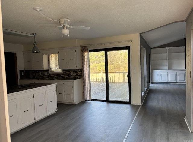 240 Timberlane Dr, Magnolia, AR 71753 - kitchen with dark countertops, dark wood-style floors, white cabinetry, and a ceiling fan