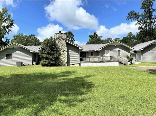 240 Timberlane Dr, Magnolia, AR 71753 - rear view of house featuring a lawn, a chimney, and metal roof
