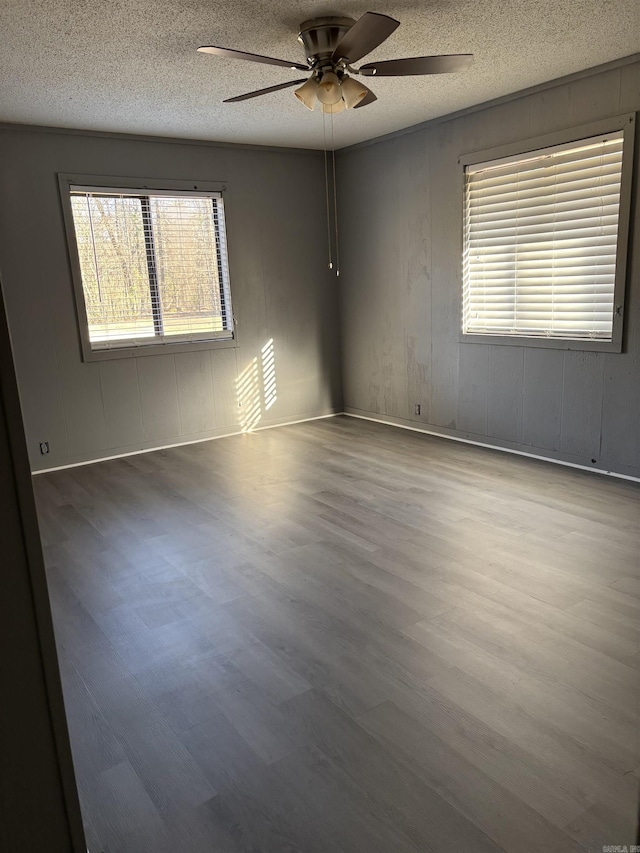 240 Timberlane Dr, Magnolia, AR 71753 - spare room featuring wood finished floors, a textured ceiling, and ceiling fan