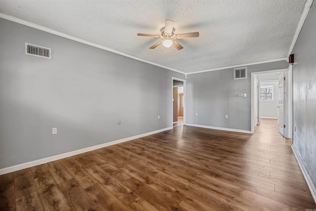 unfurnished room featuring visible vents, ornamental molding, a ceiling fan, and wood finished floors