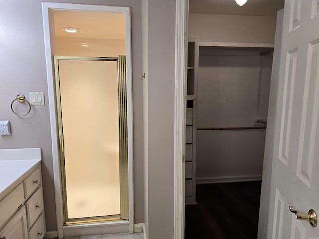 bathroom featuring a stall shower and vanity